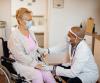 Senior woman in wheelchair with doctor