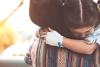 Sick girl hugging mom in hospital
