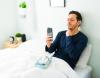 Sick man checking throat in bed