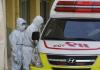 Healthcare workers outside ambulance