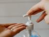Squirting hand sanitizer onto hand