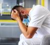 Stressed healthcare worker wearing mask