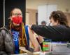 Masked teacher getting COVID vaccine