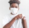 Teen boy with post-vaccine bandaid