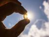 Vitamin D capsule held in front of sun