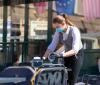 Waitress with mask disinfects tables