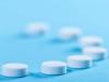 White pills blue background