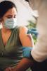Woman getting prepped for vaccine in arm