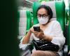 Woman on train wearing respirator