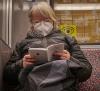 Woman reading and wearing N95 respirator