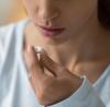Woman taking white pill