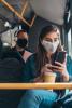 Woman wearing mask on bus