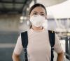 Woman wearing respirator in airport