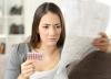 Woman with pill packet and long instruction sheet