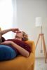 Woman with sinus headache on couch