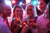 Young adults clinking drinks