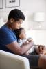 Young dad with baby on lap