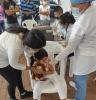 Young girl getting COVID vaccine in Colombia