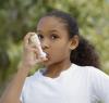 Young girl using inhaler