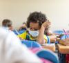 Young student wearing mask in classroom